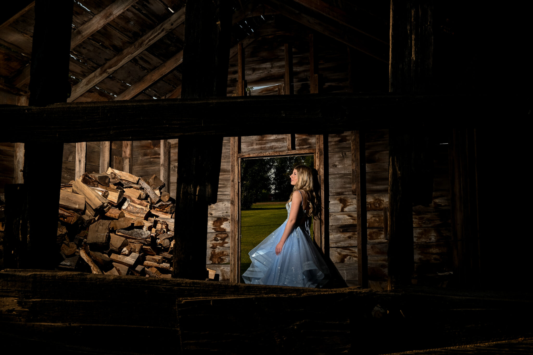 Graduate in a blue dress, photographed in a rustic barn for a gorgeous impactful image